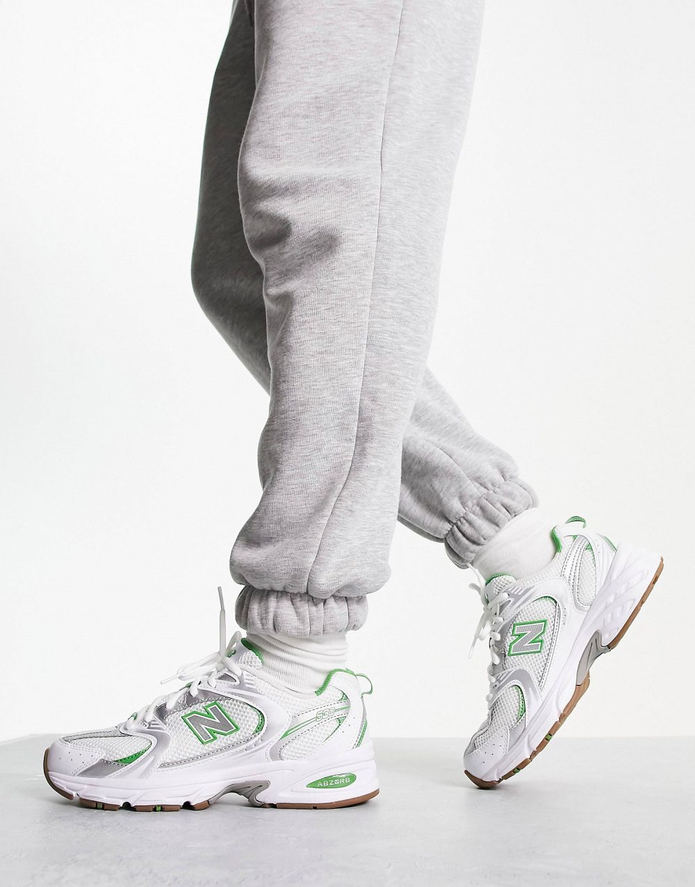 New Balance 530 trainers in white & green